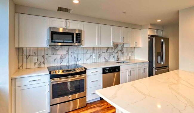 Select homes feature upgraded kitchens with quartz countertops - The Sterling Apartment Homes