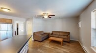 Located at 5801 Copper Beech Blvd in Kalamazoo, Michigan, this one-bedroom, one-bathroom unit offers a practical and comfortable single-floor layout. The open-concept living and kitchen area forms the heart of the unit, with warm wood-look flooring running throughout. The living room provides a welcoming space with a ceiling fan, a wall-mounted air conditioning unit, and a window that lets in natural light. The kitchen is well-equipped with warm oak cabinetry, dark countertops, a mosaic tile backsplash, stainless steel appliances including a dishwasher and refrigerator, and a double sink — offering both functionality and style. The spacious bedroom features plush carpeting, a ceiling fan, a window with blinds, and a closet, creating a quiet and comfortable retreat. The bathroom is clean and bright, appointed with a white vanity, a large mirror with overhead lighting, wood-look flooring, and a full tub-shower combination. A textured ceiling is found throughout the unit, adding a classic finishing touch. This unit offers a well-organized and efficient layout well-suited for comfortable everyday living in Kalamazoo.