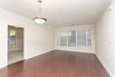 Located at 567 Rock Springs Pl NE in Atlanta's vibrant 30306 zip code, this single-floor residence offers a well-designed layout with thoughtful finishes throughout. The main living area showcases rich hardwood flooring, crown molding, and a pendant light fixture, creating an elegant yet welcoming ambiance. Natural light filters in through multiple windows dressed with blinds, lending a bright, airy feel to the space.

The kitchen is outfitted with warm, rich wood cabinetry, granite countertops, stainless steel appliances including a range and over-the-range microwave, and a decorative tile backsplash — combining both style and functionality.

The bedrooms are carpeted for comfort and feature large windows that invite generous natural light and outdoor views. Ceiling fans provide added climate control in the primary living spaces.

A hallway connects the bedrooms to well-appointed bathrooms. The primary bathroom offers a dual-sink vanity with granite countertops, white cabinetry, tile flooring, and a large mirror with elegant sconce lighting. Additional closet and storage space is accessible off the hallway, enhancing the overall practicality of the floor plan.

Throughout the residence, neutral warm tones, white trim, and consistent finishes create a cohesive and inviting atmosphere.