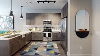 Located in the NoDa neighborhood of Charlotte, NC, this single-floor residence offers a thoughtfully designed layout with contemporary finishes throughout. The kitchen is a standout feature, equipped with stainless steel appliances including a French door refrigerator, gas range, and built-in microwave. Rich gray-toned cabinetry extends to the ceiling, providing ample storage, while white quartz countertops and a subway tile backsplash add a clean, modern aesthetic. Track lighting and wood-look flooring complete the space. The living area is bright and welcoming, with large windows dressed in warm rust-toned curtains that invite natural light. The bedroom is generously sized, featuring plush carpeting, large windows with patterned drapes, and a ceiling fan. The bathroom is designed with a full tub-shower combination, tiled in a bold black-and-white pattern, paired with a gray vanity, quartz countertop, and a large mirror. Wood-look flooring ties the space together seamlessly. Overall, this residence combines modern urban design with functional living spaces, making it an ideal home in one of Charlotte's most vibrant cultural districts.