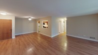 Located at 913 Timber Ln in Darien, Illinois, this single-floor home offers a well-organized layout with functional living spaces throughout. The open living area features warm hardwood flooring and neutral-toned walls, creating a bright and inviting atmosphere. A pass-through opening connects the living area to the kitchen, enhancing the sense of openness between spaces.

The kitchen is well-appointed with warm wood cabinetry, light countertops, and tile flooring. It includes a full suite of stainless steel appliances — refrigerator, range, microwave, and dishwasher — along with a double-basin sink and ample upper and lower cabinet storage.

The bedrooms are generously sized, each featuring hardwood floors and windows that bring in natural light with views of surrounding greenery. At least one bedroom includes access to a dedicated closet and an en-suite bathroom equipped with a walk-in shower, wood vanity, and tile flooring.

A second full bathroom serves the remaining rooms, complete with a tub-shower combination, a wide vanity with a single sink, and a large mirror. Both bathrooms feature tile flooring and clean, minimal finishes.

Overall, the home presents a clean, functional design with consistent finishes throughout, making it a practical and comfortable single-level living space in a residential Darien neighborhood.