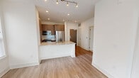 Located at 401 N Gulph Rd in King of Prussia, PA, this well-appointed one-bedroom, one-bathroom residence offers a thoughtfully designed open-concept layout with modern finishes throughout. Light-toned hardwood-style flooring flows seamlessly across the main living areas, complementing the clean white walls and creating a bright, airy ambiance.

The kitchen serves as a centerpiece of the space, featuring a peninsula island with a granite countertop and a deep double-basin sink with a professional-style pull-down faucet. Rich wood-toned cabinetry extends to the ceiling, providing ample storage, while a full suite of stainless steel appliances — including a French door refrigerator, electric range, and microwave — complete the modern culinary setup. The kitchen opens directly into the living area, which benefits from generous natural light through large windows dressed with horizontal blinds.

The bedroom is a serene retreat, featuring a ceiling fan, wide sliding glass doors that fill the room with natural light, and easy access to a dedicated closet. The bathroom continues the refined aesthetic with granite vanity countertops, wood-toned cabinetry, a framed mirror, and elegant light marble-style tile flooring. Recessed lighting throughout adds to the polished, contemporary feel of this well-designed residence.