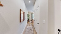 Located in Conroe, TX, this thoughtfully designed single-floor unit maximizes its compact footprint with an efficient, open-concept layout. Light wood flooring runs throughout, lending warmth and visual continuity across every room.

The living area is bright and welcoming, anchored by large windows that draw in abundant natural light and offer outdoor views. A ceiling fan adds comfort, while the open layout connects seamlessly to the dining area and kitchen.

The kitchen is well-appointed with tall white shaker cabinets reaching toward the ceiling, a subway tile backsplash, stainless steel appliances including a refrigerator, range, over-the-range microwave, and dishwasher, and a clean white countertop with a functional sink — all designed to make the most of the available space.

A hallway lined with recessed lighting connects the main living areas to the private spaces, including a cozy bedroom with neutral tones and ample closet storage across three dedicated closets. The two bathrooms are cleanly finished, one featuring a walk-in shower with a black-framed glass door and white tile surround.

A dedicated laundry area adds everyday convenience. The overall ambiance is modern yet warm, with a neutral palette and recessed lighting creating a comfortable, inviting atmosphere throughout.