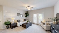 Located at 831 Pecan Ave in Winston-Salem, NC, this 2-bedroom, 1-bathroom single-floor home offers a thoughtfully designed layout that maximizes every inch of its intimate footprint. The living area is warm and inviting, featuring plush carpeting, a ceiling fan, and elegant French doors that flood the space with natural light while providing a seamless connection to the outdoors. A second living area extends the flexibility of the floor plan, ideal for a home office or den. The combined dining room and kitchen area is a functional highlight, with the kitchen showcasing gray cabinetry, granite-style countertops, wood-look flooring, and a full suite of stainless steel appliances. The adjacent dining space offers a cozy nook perfect for everyday meals. The primary bedroom provides a generous retreat with double closet doors and carpeted flooring, while a dedicated closet with wire shelving adds practical storage. The full bathroom features a tub-shower combination with wood-look tile flooring. A dedicated laundry room with hookups and overhead shelving adds everyday convenience. Neutral tones and clean finishes throughout lend the home a bright, cohesive aesthetic.