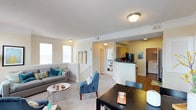This well-appointed 2-bedroom, 2-bathroom residence offers a thoughtfully designed layout across a single floor. The open-concept living and dining area is bathed in natural light from multiple large windows, and features warm neutral tones, plush carpet flooring, crown molding, and a classic fireplace as a central focal point — creating an inviting, comfortable atmosphere. The kitchen is efficiently designed with light maple cabinetry, dark granite-style countertops, a stainless steel sink, and black appliances including a refrigerator and dishwasher. Both bedrooms are generously sized with plush carpeting and ceiling fans, offering a restful retreat. One bedroom includes a walk-in closet, while the other provides balcony access with outdoor views. Each of the two full bathrooms features granite-topped white vanities and a tub/shower combination with hardwood-style flooring, adding a clean, polished finish. A dedicated in-unit laundry room with a full-size washer and dryer adds everyday convenience. Overall, this residence combines functional design with comfortable living spaces, making it an ideal home for a variety of lifestyles.
