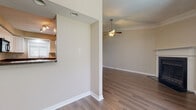 Located at 2777 Enterprise Rd E in Clearwater, Florida, this single-story residence offers a well-organized layout with a variety of functional living spaces. The living room serves as a central gathering area, featuring crown molding, a ceiling fan, a textured ceiling, and a fireplace that adds a distinctive focal point to the room. Wood-look flooring flows throughout the main living areas, contributing to a cohesive and clean aesthetic.

The kitchen is outfitted with white shaker-style cabinetry, dark granite-style countertops, and stainless steel appliances including a range and refrigerator, complemented by a black microwave. Track lighting illuminates the workspace, and a pass-through opening connects the kitchen to the adjacent living area, enhancing the open feel of the layout.

The bedrooms are carpeted for comfort and each include ceiling fans and windows with blinds that allow natural light while maintaining privacy. The bathrooms are finished with wood-look flooring, white fixtures, and a tiled tub-shower combination. A dedicated laundry area houses a full-sized washer and dryer. A programmable thermostat and accessible utility panel are conveniently located near the entry of the unit.