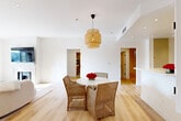 Located on Butler Avenue in the heart of West Los Angeles, this thoughtfully designed single-story home offers five bedrooms and three bathrooms with a clean, modern aesthetic throughout. Light hardwood floors flow seamlessly across the entire floor plan, creating a warm and cohesive feel from room to room.

The open living and dining area serves as the heart of the home, anchored by a classic fireplace beneath a wall-mounted TV and illuminated by a woven rattan pendant light above the dining table. The layout connects effortlessly to the kitchen, which features white shaker cabinetry extending to the ceiling, stainless steel appliances including a gas range and French-door refrigerator, and a crisp white peninsula countertop ideal for casual dining or meal prep.

The primary bedroom is generously proportioned and includes custom built-in shelving and drawers with brushed gold hardware, bathed in natural light through slatted windows. A dedicated walk-in closet provides ample storage with full-length hanging rails. Additional bedrooms are well-sized and versatile.

The bathrooms are finished in a contemporary style, featuring floating wood-toned vanities with white countertops, light tile flooring, plantation shutters, and open shelving for storage. A central hallway connects the private quarters with matte black door hardware adding a modern accent throughout the home.