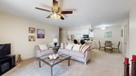 Located at 484 Crestmont Ct in Copley, Ohio, this single-floor, 2-bedroom, 2-bathroom residence offers a comfortable and functional layout across a well-utilized footprint. The open-concept living area is warm and inviting, featuring neutral carpeting, soft wall tones, and a ceiling fan overhead. The space flows seamlessly into the kitchen and dining area, creating an ideal setting for both everyday living and entertaining. The kitchen is equipped with white cabinetry, a built-in microwave, range, and refrigerator, and features a peninsula breakfast bar with seating — a practical and social focal point. A dedicated dining area adjacent to the kitchen provides additional space for meals. The primary bedroom is generously sized, offering a large window that allows ample natural light and views of the surrounding greenery, complemented by plush carpeting and convenient closet access. The second bedroom is equally well-appointed. Both bathrooms are clean and functional, with one featuring a full tub and shower combo with tile flooring. The residence also includes two laundry areas, a utility room, and five closets, ensuring abundant storage throughout. The overall ambiance is bright, neutral, and move-in ready.