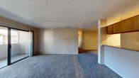 Located at 2800 N Tracy Blvd in Tracy, CA, this single-floor, 3-bedroom, 1-bathroom home offers a practical and functional layout. The living room serves as the centerpiece of the space, featuring plush carpeting, a tile-surround fireplace, and a sliding glass door that opens to a private patio, allowing for natural light and outdoor access. A textured ceiling and neutral-toned walls run throughout, creating a cohesive and understated aesthetic.

The kitchen is efficiently designed with light tile flooring, warm wood cabinetry, ample upper cabinet storage, a gas range, and a full-size refrigerator. A built-in range hood and overhead fluorescent lighting keep the space bright and functional.

The three bedrooms are carpeted and feature neutral walls, with the bedrooms offering closet storage with hanging rods. One bedroom includes a window with a view of outdoor greenery, bringing in natural light. The hallway connects the bedrooms to the shared bathroom area, which is split into a vanity section with warm wood cabinetry and a large mirror, and a separate water closet with hardwood-style flooring, a toilet, and additional cabinetry. The overall layout is straightforward and well-suited for comfortable everyday living.