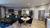 Located at 901 S Winchester Blvd in San Jose, California, this single-floor residence showcases a thoughtfully designed open-concept layout with contemporary finishes throughout. Light wood-tone flooring flows seamlessly through the main living areas, complementing the neutral gray walls and recessed lighting overhead.

The kitchen is a standout feature, outfitted with sleek white cabinetry, a clean white countertop, under-cabinet lighting, and a full suite of stainless steel appliances including a refrigerator, gas range, microwave, and dishwasher. The kitchen opens directly to the dining area, where a marble-topped round table with gold-accented base serves as an elegant focal point.

The living area offers a cozy, curated atmosphere, anchored by a tufted emerald green velvet sofa beneath a gallery-style art display. A large mirror enhances the sense of depth and light in the shared living and dining space.

The bedroom features plush carpet flooring, a deep teal accent wall with gallery art, and a generously sized walk-in closet with built-in shelving. Natural light enters through large windows with views of the surrounding neighborhood.

The bathroom is finished with patterned teal wallcovering, a wood-toned vanity with white countertop, subway-tiled tub surround, and clean tile flooring, completing this well-appointed residence.