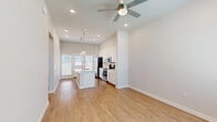 Located at 2600 Lake Forest Dr in McKinney, TX, this well-designed one-bedroom, one-bathroom unit offers a thoughtful single-floor layout that maximizes every square foot. The open-concept living and kitchen area forms the heart of the space, featuring warm wood-look flooring, recessed lighting, and a ceiling fan that enhances airflow and comfort. Natural light filters in through blinded windows, creating a bright and welcoming atmosphere.

The kitchen is a standout feature, showcasing white shaker cabinetry that extends to the ceiling for generous storage, a classic subway tile backsplash, and a full suite of stainless steel appliances including a side-by-side refrigerator, electric range, and built-in microwave. A central island with a quartz countertop and an undermount sink serves as both a prep area and casual dining spot, accented by stylish pendant lighting above.

The bedroom offers a calm, neutral retreat with a ceiling fan and a window that brings in natural light. It connects to a dedicated closet with built-in hanging rods. The bathroom is clean and functional, featuring quartz countertops, white cabinetry, and a full tub-shower combination with large-format tile surround. A separate laundry room includes a full-size front-loading washer and dryer with additional shelving for storage.
