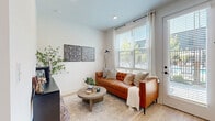 Located at 35 Flax Street in Delaware, Ohio, this thoughtfully designed one-bedroom, one-bathroom unit makes excellent use of its compact footprint across a single floor. The open-concept kitchen and living area serves as the heart of the home, where natural light pours in through large windows fitted with blinds and sheer curtains. A glass door leads directly to a private patio, offering a seamless connection to the outdoors.

The galley-style kitchen is well-appointed with white shaker cabinetry, matte black hardware, white quartz countertops, a classic square tile backsplash, and a full suite of stainless steel appliances including a range, over-the-range microwave, dishwasher, and refrigerator. Light hardwood flooring flows consistently throughout the entire unit, lending warmth and visual continuity.

The bedroom is a cozy, functional space with its own dedicated area and access to two closets for ample storage. The bathroom features a white shaker vanity with a white countertop, a sleek black-framed mirror, matte black fixtures, and wood-look tile flooring, maintaining the clean, modern aesthetic found throughout. An in-unit laundry area adds everyday convenience. The overall ambiance is bright, clean, and contemporary.