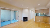 Located at 1348 N Sierra Bonita Ave in Los Angeles, CA 90046, this 2-bedroom, 2-bathroom apartment offers a thoughtfully designed single-floor layout with clean, modern finishes throughout. Light-toned bamboo hardwood flooring runs consistently across the living areas and bedrooms, lending warmth and visual continuity to the space.

The living room is bright and open, anchored by recessed lighting and large sliding glass doors that lead to a private balcony with neighborhood views. The kitchen features light maple cabinetry, dark countertops, stainless steel appliances, and a convenient pass-through bar that connects to the main living area.

The primary bedroom is generously proportioned, offering two mirrored sliding-door closets and direct access to its own private balcony, flooding the room with natural light and outdoor greenery views. The second bedroom is well-sized with recessed lighting and its own closet access.

Both bathrooms are finished with a cohesive modern aesthetic, featuring warm wood-toned vanity cabinetry, gray countertops, and tiled shower-tub combinations accented with decorative mosaic tile borders and built-in niches. A central hallway efficiently connects all rooms, enhancing the functional flow of the layout. Recessed lighting throughout provides consistent, clean illumination across the entire unit.