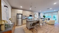 Located at 417 Callowhill Street in Philadelphia's vibrant Callowhill neighborhood, this well-appointed one-bedroom, one-bathroom unit offers a thoughtfully designed open-concept layout across a single floor. Light wood flooring flows throughout, lending warmth and continuity to every room.

The kitchen and living area form the heart of the unit. The kitchen features light wood cabinetry extending to the ceiling, dark countertops, a white subway tile backsplash, stainless steel appliances, and a central island with bar seating and pendant lighting overhead. The adjoining living area is bright and airy, with recessed lighting and a window that fills the space with natural light. A private balcony accessible from the living area offers open views of the surrounding urban streetscape and the building's landscaped courtyard below.

The bedroom is a comfortable, well-proportioned retreat with light wood flooring, neutral walls, and direct access to a dedicated walk-in closet. The full bathroom is finished with large-format tile flooring, a wood-toned vanity with a dark countertop, and a clean, minimalist aesthetic. Recessed lighting throughout the unit contributes to a modern, polished ambiance that suits both everyday living and entertaining.