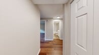 Located at 433 Bellevue Way SE in the heart of Bellevue, Washington, this well-appointed 2-bedroom, 1-bathroom residence offers a thoughtfully designed single-level layout. Rich hardwood flooring runs throughout every room, lending warmth and visual continuity across the entire space.

The open living area is bright and welcoming, featuring recessed lighting, a sliding glass door, and a large picture window that frame lush, wooded views and lead out to a private balcony with a sleek metal railing. The kitchen has been tastefully updated with crisp white shaker cabinetry, quartz countertops, a mosaic tile backsplash, and stainless steel appliances, including a refrigerator and dishwasher, along with a peninsula that provides added prep and serving space.

Both bedrooms are comfortably sized and equipped with ceiling fans. The primary bedroom features a double-door closet and hardwood floors, while the second bedroom benefits from natural light through a dedicated window. The bathroom continues the refined aesthetic with white cabinetry, a quartz vanity countertop, and brushed nickel fixtures. A connecting hallway links all rooms efficiently, completing this clean, move-in-ready layout in one of Bellevue's most sought-after addresses.