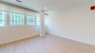 Located at 8605 Cameron St in Silver Spring, Maryland, this one-bedroom, one-bathroom unit offers a thoughtfully designed layout across a single floor. Light wood flooring runs throughout, complementing a clean, modern aesthetic defined by crisp white walls and recessed lighting.

The galley-style kitchen is a standout feature, equipped with stainless steel appliances including a refrigerator, range, microwave, and dishwasher. Gray shaker-style cabinetry extends to the ceiling for ample storage, while white quartz countertops and a herringbone-pattern tile backsplash add refined detail. The kitchen opens toward a combined living and dining area bathed in natural light from multiple windows with urban views.

The bedroom is an intimate, well-proportioned space with a large window overlooking the surrounding cityscape, offering abundant natural light. Three closets throughout the unit provide generous storage options.

The bathroom features a walk-in glass-enclosed shower finished with classic white subway tile and contrasting dark floor tile, lending a clean and contemporary feel. The hallway connecting the rooms is bright and efficient, with a smart thermostat and modern gold-toned hardware adding subtle upscale touches. The entrance flows directly into the kitchen and living area, creating a cohesive and functional floor plan ideal for everyday living.