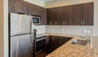 Modern kitchens with stainless steel appliances and granite countertops - SouthStar Lofts