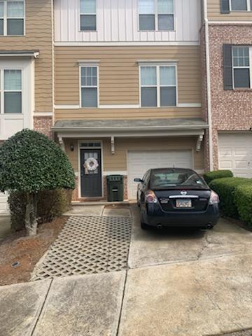 Front door and garage entrance with additional parking space - 1798 Oakbrook Ln NW