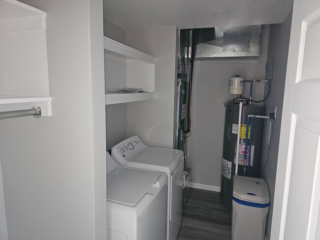 Utility room with garage access and washer/dryer included. - 1510 W 32nd St