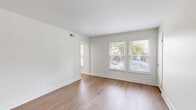 Located at 200 Mal Mae Ct in Williamsburg, Virginia, this two-bedroom, one-bathroom single-story home offers a clean, modern aesthetic with thoughtful updates throughout. The living room welcomes you with warm hardwood-style flooring, crisp white walls, and multiple windows that fill the space with natural light and views of the surrounding neighborhood. The fully updated kitchen is a standout feature, showcasing white shaker-style cabinetry extending to the ceiling, a classic subway tile backsplash, stone-look countertops, and a full suite of stainless steel appliances including a refrigerator, electric range, dishwasher, and built-in microwave hood. Both bedrooms offer a comfortable and quiet retreat, with plush carpeting, natural light from window, and generous closet space — including double-door closets in the secondary bedroom. The home includes five closets in total, providing ample storage throughout. The full bathroom is finished in clean white tones with a shower-tub combination. Connecting hallways and a dedicated utility room round out the functional layout of this well-maintained Williamsburg residence.