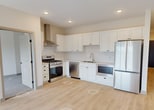 This well-designed 890 square foot home in Victoria, Minnesota offers a harmonious blend of functionality and style. The single-story layout encompasses two bedrooms, including a spacious 130 square foot primary bedroom, and two full bathrooms. The kitchen boasts modern appliances, including a sleek stainless steel range with a hood, and ample white cabinetry for storage. Light wood flooring throughout creates a cohesive, airy feel, complemented by neutral wall tones. The bathrooms feature contemporary fixtures, with one showcasing a double vanity and walk-in shower. A dedicated laundry room with side-by-side appliances enhances convenience. Generous closet spaces with wire shelving systems provide excellent organization. Large windows in the bedrooms and living areas flood the space with natural light, while sliding glass doors in the main living area lead to an outdoor space. The home's efficient design maximizes every square foot, creating a comfortable and modern living environment.