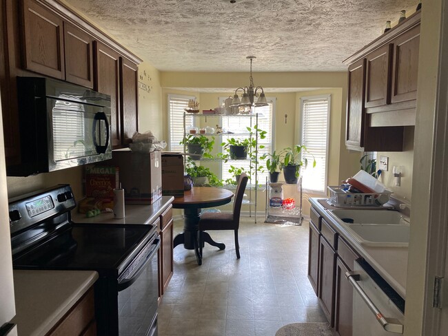 Garage entry to kitchen and dining area beyond - 1487 Oldstead Dr