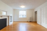 Located at 96 Isabella Street in Toronto's vibrant Midtown neighbourhood, this single-floor unit offers a thoughtfully organized layout comprising four rooms. Warm hardwood flooring runs throughout the main living areas, lending a classic character to the space.

The living room is a standout feature, highlighted by a charming decorative fireplace with a white-painted mantel and built-in shelving on either side. A large window fills the room with natural light and offers views of the surrounding neighbourhood. A set of French doors adds an elegant touch, separating the living space from the adjacent room.

The kitchen is clean and functional, featuring white cabinetry, white subway tile backsplash, a dark countertop with an integrated sink, and a freestanding electric range. A window above the counter brings in natural light, making the space feel open despite its compact footprint.

The bathroom retains a vintage character with classic white hex floor tile, white ceramic wall tile on the lower half, and a bold green accent on the upper walls and trim. It is equipped with a pedestal sink and a window for ventilation and natural light.

A connecting hallway ties the rooms together efficiently. Throughout the unit, white walls and trim create a bright, cohesive aesthetic that complements the warm tones of the hardwood floors.