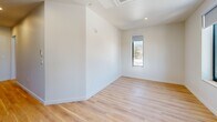 Located at 319 N Pottstown Pike in Exton, PA, this thoughtfully designed one-bedroom, one-bathroom residence offers a clean, modern aesthetic across a single floor. Light wood flooring runs throughout, complementing the bright white walls and recessed lighting that give the space an open, airy feel.

The entrance leads into a galley-style kitchen outfitted with sleek white cabinetry, stainless steel appliances including a refrigerator and dishwasher, and a window that draws in natural light. The layout flows naturally into the living area, which provides a comfortable, well-proportioned space for everyday living.

The bedroom is a well-sized retreat featuring a large double-door closet for ample storage and a tall narrow window that frames outdoor views. A dedicated laundry area includes a front-loading washer and stacked cabinetry above, along with its own window for added brightness.

The bathroom is finished in a contemporary style, showcasing a full-size walk-in shower enclosed by frameless sliding glass doors, white tile surround, and warm wood-toned flooring that ties the space together cohesively. Every room reflects a minimalist design sensibility with clean lines and quality finishes, making this Exton residence a polished and functional living space.