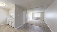 Located at 12164 W Nevada Dr in Lakewood, Colorado, this single-floor, 3-bedroom, 2-bathroom residence offers a functional and well-organized layout. The open living area transitions seamlessly from wood-look luxury vinyl flooring near the kitchen into a carpeted living room, creating a distinct yet connected flow. A window with vertical blinds allows natural light to fill the space, while a wall-mounted air conditioning unit and baseboard heating provide year-round climate control. The textured ceilings are consistent throughout, lending a classic character to each room.

The three bedrooms are carpeted and finished in neutral tones, each featuring baseboard heating and windows with vertical blinds. The primary bedroom provides a comfortable and private retreat. Secondary bedrooms are well-proportioned and versatile. Each bedroom benefits from practical built-in or bi-fold closet storage. A dedicated closet offers additional storage capacity.

Both bathrooms are clean and efficiently designed. One features a full tub-shower combination with white tile surround, wood-look flooring, and brushed nickel fixtures. A second bathroom with a stone-look vanity countertop connects conveniently to the hallway. The in-unit laundry room houses a full-size washer and dryer with shelving on both sides, adding significant everyday convenience to this Lakewood home.