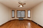Located at 826 Maplehurst Ct in Knoxville, Tennessee, this single-floor home showcases a wealth of classic architectural character. The living area is accessed through a distinctive rounded archway and features warm hardwood flooring, a ceiling fan, and multi-pane windows framed in rich wood trim that fill the space with natural light. A charming built-in wall niche with shelving adds a decorative vintage touch near the entry.

The main living space is open and airy, with additional arched doorways carrying the home's signature design language throughout. A wall-mounted mini-split unit provides climate control, and a second built-in arched display niche with shelving serves as a refined architectural accent. Dark wood doors and baseboards complement the honey-toned hardwood floors, creating a cohesive, warm aesthetic.

The kitchen features a classic black-and-white checkered tile floor, white cabinetry, a white electric range, and a refrigerator, with a multi-pane window providing natural light. The bathroom continues the vintage theme with mosaic tile flooring, white subway tile wainscoting, a pedestal sink, a soaking tub, and a dark wood door with original hardware. Together, these spaces reflect a well-preserved, character-rich home with timeless design details.