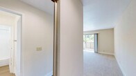 Located at 2366 American River Dr in Sacramento, CA, this one-bedroom, three-bathroom unit offers a well-organized single-floor layout designed for comfortable everyday living. The combined kitchen and living room area forms the heart of the space, where the kitchen features light wood cabinetry, speckled stone countertops, wood-look flooring, and white appliances including a range, over-the-range microwave, and refrigerator. A peninsula counter neatly separates the kitchen from the carpeted living area, which is filled with natural light and includes a ceiling fan. Sliding glass doors open to a private balcony overlooking lush greenery, bringing the outdoors in. The bedroom is a well-proportioned retreat with plush carpet, neutral walls, and a window framing peaceful outdoor views. The three bathrooms are finished consistently with light wood vanities, speckled stone countertops, large mirrors, and wood-look flooring. At least one bathroom includes a full tub and shower combination with clean white surround. Throughout the unit, warm beige tones, white trim, and abundant natural light create a bright, cohesive ambiance that feels open and inviting.