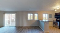 Located at 95 Kentucky Dr in Newport, Kentucky, this single-floor home offers a well-designed layout with a clean, updated aesthetic throughout. The open-concept living and dining area is bright and welcoming, featuring light hardwood-style flooring, neutral-toned walls, and a textured ceiling. Multiple windows along the main living space flood the interior with natural light and provide pleasant views of the surrounding greenery. A glass door leads directly to an outdoor deck, extending the living space outdoors.

The kitchen is a standout feature, showcasing rich dark wood cabinetry with decorative crown molding, granite countertops, and a striking mosaic glass tile backsplash in complementary tones. A peninsula counter with a dark granite top provides additional prep and seating space. The kitchen is equipped with stainless steel appliances, including a range and dishwasher.

The bedrooms offer comfortable, versatile spaces with light hardwood-style flooring, neutral walls, and ceiling fans with integrated lighting. Natural light filters in through well-placed windows. The bathroom is efficiently appointed with a vanity featuring dark wood cabinetry, a tiled tub-shower combination, and light hardwood-style flooring. Throughout the home, consistent finishes and thoughtful details create a cohesive, move-in-ready living environment.