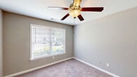 Located at 205 Arthur Dr in Thomasville, NC, this single-floor unit offers a well-organized and functional layout across a compact but efficient footprint. The kitchen is thoughtfully designed with warm honey-toned wood cabinetry — including glass-front upper cabinets — light speckled countertops, wood-look flooring, and a full suite of appliances including a freestanding electric range, refrigerator, and stainless steel sink. A range hood is positioned above the stove, adding practical ventilation to the space.

The bedroom is a comfortably sized retreat featuring soft wall-to-wall carpeting, neutral gray-toned walls, and a ceiling fan with integrated lighting. A window with blinds allows natural light to filter in, offering views of the surrounding greenery. A double-door closet provides ample storage, making the room both functional and inviting.

The bathroom is clean and straightforward, featuring a tub and shower combination with a curved curtain rod, a toilet, and an overhead wood cabinet for additional storage. Wood-look flooring ties the space together with the kitchen's aesthetic.

Overall, this unit presents a practical and cohesive living space with consistent finishes throughout, well-suited for comfortable single-occupant living in Thomasville, NC.