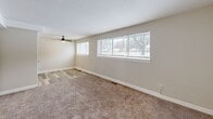 Located on Belvoir Avenue in Cleveland, OH, this 2-bedroom, 1-bathroom unit offers a practical and well-organized single-floor layout. The living area features neutral-toned walls, plush carpeting, and a ceiling fan, with large windows that allow ample natural light and views of the surrounding neighborhood. The spacious primary bedroom is generously sized, also outfitted with carpet, a ceiling fan, and a closet for storage. The second bedroom similarly features carpet, a ceiling fan, and a window that brightens the room. The kitchen is equipped with hardwood-style flooring, granite-look countertops, a refrigerator, and a window above the counter area that brings in natural light. The bathroom is cleanly finished with full tile surround walls, a tub-shower combination, a white vanity with storage, a mirrored medicine cabinet, and hardwood-style flooring — plus a window for added ventilation. Throughout the unit, consistent neutral tones and clean white trim create a cohesive, move-in ready aesthetic. Ceiling fans are present in multiple rooms for added comfort, and windows throughout ensure the space feels bright and connected to its surroundings.
