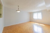 Located at 30 Elm Dr E in Mississauga, Ontario, this one-bedroom unit offers a practical and well-organized single-floor layout. Throughout the living areas and bedroom, warm-toned parquet hardwood flooring adds a classic character to the space, complemented by clean white walls and textured ceilings.

The hallways connect the rooms efficiently, with flush ceiling lighting and consistent flooring that creates a cohesive flow throughout. The living area is bright and open, benefiting from a window fitted with vertical blinds that allows natural light to filter in and offers views of surrounding greenery.

The bedroom is a comfortable size, featuring a large window with vertical blinds that frames a pleasant outdoor view of trees, allowing ample natural light to fill the room. A ceiling vent ensures climate control throughout.

The kitchen is functionally designed with white cabinetry both above and below the counter, providing generous storage. It includes a double-basin sink, a granite-style laminate countertop, and a white coil-top electric range with oven. The kitchen flooring transitions to a lighter tile, distinguishing it from the rest of the unit.

Overall, this unit presents a clean, neutral palette with practical finishes, making it a straightforward and functional living space in a residential Mississauga setting.