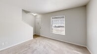 Located at 5460 Countryside Drive in Winston-Salem, NC, this two-story home offers a practical and comfortable layout spread across two floors. The main level hosts the primary living areas, including a carpeted living room with a front entry door and a window that brings in natural light. The kitchen is well-equipped with white cabinetry, dark granite-style countertops, wood-look vinyl flooring, and black appliances including a refrigerator, electric range, and dishwasher. A dedicated laundry area and two full bathrooms — each featuring a tub/shower combination — round out the functional amenities. Two staircases connect the floors, offering convenient circulation throughout the home. The upper level contains the bedrooms, each finished with plush carpet, ceiling fans with light fixtures, and windows that invite natural light and outdoor views. The primary bedroom includes a sliding-door closet, while three closets total provide ample storage throughout the home. Neutral gray and white tones, textured ceilings, and clean finishes give the space a bright, move-in-ready feel. This home combines efficient use of space with practical features suited for everyday living.