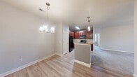 This single-story, 3-bedroom, 2-bathroom home in Fayetteville, NC offers a functional and well-organized layout with a comfortable, move-in-ready feel. The open-concept main living area seamlessly connects the kitchen, dining, and living spaces. The kitchen features rich cherry-toned cabinetry, granite-style countertops, a kitchen island with a breakfast bar, pendant lighting, and black appliances including a range and built-in microwave. Light hardwood-style flooring flows through the main living areas, while plush carpet adds warmth to the bedrooms and living room. Each bedroom includes a ceiling fan and generous closet space — the home features four closets in total, including a well-appointed walk-in closet with wire shelving. The primary bedroom is a comfortable, well-proportioned retreat. The bathrooms are clean and functional, featuring a tub/shower combo with brushed nickel fixtures. A dedicated laundry room provides washer and dryer hookups with overhead wire shelving for added storage. Additional utility and pantry spaces round out the home's practical amenities, making this a well-equipped residence suited for everyday living.
