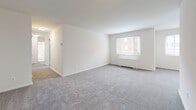 Located at 2040 Columbia Pike in Arlington, VA, this 2-bedroom, 1-bathroom residence offers a well-organized, single-floor layout designed for comfortable everyday living. The entrance leads into a generous living room featuring soft wall-to-wall carpeting, crisp white walls, and a large window that draws in natural light and offers views of the surrounding neighborhood. An adjoining dining area provides a dedicated space for meals, flowing naturally from the living room. The galley-style kitchen is efficiently designed with dark cabinetry, granite-style countertops, a gas range, dishwasher, and refrigerator, all complemented by wood-look flooring that adds warmth to the space. Both bedrooms are carpeted and well-proportioned, each equipped with ceiling fans for year-round comfort and windows that allow natural light to fill the rooms. The spacious primary bedroom offers a comfortable retreat. A full bathroom features a soaking tub with marble-patterned surround tile and a frosted privacy window. With six closets distributed throughout, storage is exceptionally well-served. A dedicated hallway connects the rooms cohesively, completing this practical and neatly arranged Arlington residence.