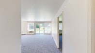 Located at 1400 Twombly Rd in DeKalb, IL, this single-floor unit offers three bedrooms, two bathrooms, and a well-organized layout across a comfortable footprint. The kitchen features dark cabinetry with ample storage, light-toned countertops, a double stainless steel sink, and light wood-style flooring, with a window that brings in natural light. The living room is generously sized with plush carpeting, baseboard heating, and large sliding glass doors that open to outdoor green views, filling the space with natural light. The primary bedroom is a spacious retreat with wide bi-fold closet doors and direct access to one of the bathrooms, providing added convenience. The additional bedrooms are carpeted and include built-in closets, with windows offering pleasant outdoor views. Both bathrooms feature classic white tile surrounds with tub-shower combinations and natural light from windows. The entrance and hallways connect the layout efficiently, while baseboard heating is present throughout. The unit's neutral color palette and clean lines give it a bright, functional character well-suited for everyday living.