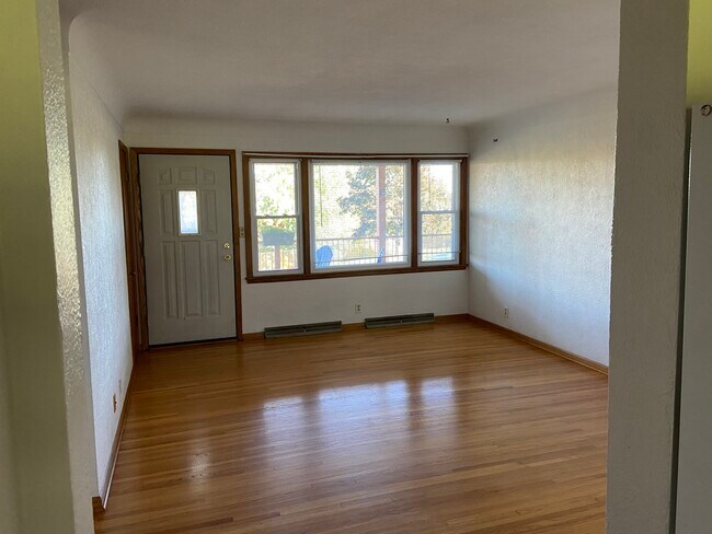 Living room with natural light and beautiful hardwood floors - 223 17th Ave N