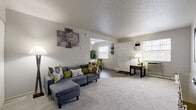 This two-bedroom, two-bathroom home in Bedford, Ohio is spread across two floors, offering a well-organized and functional layout. The main floor welcomes you with a generously sized living room featuring plush carpet flooring, neutral gray walls, and natural light streaming in through multiple windows. The space flows seamlessly into a dedicated dining area with hardwood-style flooring, a bright window, and room for a full dining set. The kitchen is outfitted with ample upper and lower cabinetry, light countertops, a stainless steel sink, and a dishwasher, complemented by the same hardwood-style flooring. A full bathroom on this level features a white vanity with storage and clean, simple finishes. Upstairs, the primary bedroom is a comfortable retreat with carpet flooring, a ceiling fan, and a walk-in closet with dual shelving systems offering generous storage. The second bedroom is also well-sized with carpet flooring. A staircase connects both levels, with additional hallway and closet space rounding out the upper floor. Throughout the home, the neutral color palette, consistent finishes, and practical layout create a cohesive and inviting living environment suitable for a variety of lifestyles.