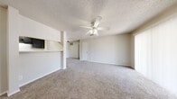 Located at 9760 Scyene Road in Dallas, Texas, this single-floor, three-bedroom, one-bathroom home offers a functional and practical layout. The combined living and dining area serves as the heart of the home, featuring plush wall-to-wall carpeting, ceiling fans with light fixtures, and a textured ceiling. A built-in pass-through counter connects this open space to the kitchen, enhancing the flow between rooms. The galley-style kitchen is equipped with dark cabinetry, white appliances including a range and refrigerator, a double-basin sink, light countertops, and wood-look vinyl flooring, providing ample storage and workspace. The primary bedroom is generously proportioned and includes a ceiling fan, carpeted floors, and closet access. The two additional bedrooms are comfortably sized, with carpet flooring and natural light provided by window blinds. One secondary bedroom features a large window overlooking the outdoors. The bathroom includes a tub/shower combination with tiled surround, a vanity with dark cabinetry, a wall mirror with overhead lighting, and wood-look vinyl flooring. Throughout the home, four closets offer excellent storage. A dedicated entrance and hallway connect the spaces efficiently, completing this well-organized and practical residence.