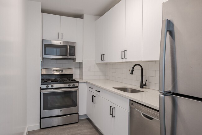 Sleek stainless steel appliances and modern cabinetry - Newport Rentals