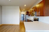 Located at 8430 Market St in Middleton, WI, this one-bedroom, one-bathroom unit offers a well-designed single-floor layout that maximizes every square foot. The open-concept living area seamlessly combines the kitchen, dining, and living spaces, creating a cohesive and functional environment. The kitchen is a standout feature, appointed with rich cherry-toned cabinetry, a white tile backsplash, stainless steel appliances including a refrigerator, electric range, microwave, and dishwasher, and a white countertop peninsula that provides additional prep and dining space. Light wood-tone flooring runs throughout the main living area, adding warmth and continuity. The living and dining area benefits from a large window and patio door that invite natural light and provide outdoor access. The bedroom is a comfortable, well-proportioned room with wood-look flooring, a large window with outdoor views, and a wall-unit HVAC system. Two closets offer generous storage throughout the unit. The bathroom features a warm wood vanity with a white countertop, a tall storage cabinet, and light tile flooring. Additional conveniences include a dedicated laundry area and a private entrance. Recessed lighting throughout keeps the space bright and modern.