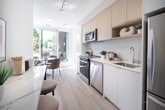 This 400 square foot apartment in Etobicoke offers a compact yet well-designed living space. The single-floor layout comprises one bedroom, one bathroom, and a hallway, efficiently utilizing every inch of the available area. The primary bedroom, measuring 90 square feet, provides a cozy retreat within the urban setting.

The apartment's modern design is characterized by light wood flooring throughout, creating a sense of warmth and continuity. Large windows in the main living area and bedroom flood the space with natural light and offer views of the surrounding cityscape, enhancing the sense of openness despite the modest square footage.

The kitchen, while compact, features contemporary appliances and cabinetry, seamlessly integrated into the open-plan living area. The bathroom, though not expansive, is designed with functionality in mind, featuring clean lines and modern fixtures.

The hallway serves as a central axis, connecting the various spaces and potentially offering additional storage solutions. The overall ambiance is one of minimalist urban living, with a focus on maximizing space and light. Located at 428-4365 Bloor St W, this apartment combines efficient design with a prime Etobicoke location, making it an ideal choice for those seeking a streamlined city lifestyle.