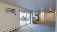 This 2-bedroom, 2-bathroom residence in New Baltimore, Michigan offers a practical single-floor layout designed for comfortable everyday living. The living room is carpeted and filled with natural light, anchored by a large sliding glass door that opens to an outdoor patio — an inviting feature that seamlessly connects indoor and outdoor spaces. A wall-mounted air conditioning unit and baseboard heating ensure year-round climate control.

The kitchen is well-equipped with warm-toned oak cabinetry offering ample storage, light countertops, and a full suite of white appliances including a gas range, dishwasher, and refrigerator. Rich, dark hardwood-style flooring grounds the kitchen and adds a contrasting warmth to the space.

Both bedrooms are carpeted and include ceiling fans for added comfort. The primary bedroom is a generously sized retreat with access to a dedicated closet. The second bedroom features a bright window with vertical blinds and its own ceiling fan. The bathrooms are cleanly finished with light-toned tile flooring and white fixtures. Throughout the residence, neutral wall colors and clean lines create a bright, move-in ready atmosphere suitable for a variety of living arrangements.
