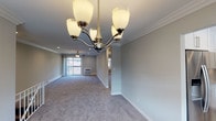 Located at 100 Terrace Road in Bayport, NY, this single-floor residence at Fairfield Courtyard at Bayport is thoughtfully designed with clean, neutral finishes throughout. The expansive living area is finished with plush wall-to-wall carpeting, crown molding, recessed lighting, and a ceiling fan, creating a bright and comfortable atmosphere. A sliding glass door opens to a private balcony, allowing natural light to fill the space. An elegant chandelier distinguishes the dining area, which flows seamlessly from the living room through a decorative column detail. The updated kitchen features crisp white cabinetry, marble-look quartz countertops, a matching backsplash, and stainless steel appliances including a gas range and built-in microwave. The bathroom has been beautifully renovated with white subway tile, a tub and shower combination with sliding glass doors, a marble-look vanity top, and classic mosaic tile flooring. Bedrooms are generously sized with soft carpeting, crown molding, ceiling fans, and ample natural light. One bedroom includes access to a well-organized walk-in closet with built-in storage. An in-unit washer and dryer add further convenience to this polished and move-in-ready residence.