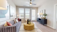 Located at 1239 E Borgfeld Dr in San Antonio, TX, this well-designed two-bedroom, two-bathroom residence offers a thoughtfully planned single-level layout. The open-concept kitchen and living area forms the heart of the home, where rich dark-cabinetry kitchen features stainless steel appliances, subway tile backsplash, and a granite-topped center island with bar seating — ideal for casual dining and entertaining. Wood-style flooring flows seamlessly throughout the entire space, lending warmth and continuity.

The living room is bright and airy, with multiple windows and a glass door providing direct outdoor access and views of the surrounding landscape. A ceiling fan adds comfort to the space, which is further enhanced by recessed lighting throughout.

Both bedrooms are well-proportioned and naturally lit, each equipped with a ceiling fan and large windows with blinds. The primary bedroom connects to a dedicated bathroom featuring a soaking tub, subway-tiled surround, dark wood vanity with granite countertop, and direct access to a generously sized walk-in closet outfitted with wire shelving systems. The second bathroom mirrors the same quality finishes. The overall aesthetic is clean, modern, and move-in ready.