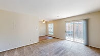 Located at 2554 Naylor Rd SE in Washington, DC, this two-bedroom, one-bathroom unit is part of a classic brick residential building surrounded by mature trees and well-maintained landscaping. The single-floor layout offers a practical and comfortable living arrangement throughout.

The living area is generously sized, featuring neutral-toned walls, plush wall-to-wall carpeting, and a ceiling fan overhead. A window allows natural light to fill the space, while a section of hardwood flooring near the window adds a subtle contrast to the carpeted areas.

Both bedrooms are carpeted and finished with the same warm neutral palette. Each room features windows that bring in natural light and views of the surrounding greenery. The spacious primary bedroom includes a closet with paneled doors, offering ample storage. The second bedroom is equally well-proportioned and bright.

The bathroom is clean and functional, featuring a full tub-shower combo with white tiled surround, a wood-vanity with a white countertop sink, and a mirrored medicine cabinet with built-in lighting above.

A private balcony extends the living space outdoors, offering pleasant views of the courtyard, walking paths, and the lush tree canopy that frames the brick building exterior — a serene retreat within the city.