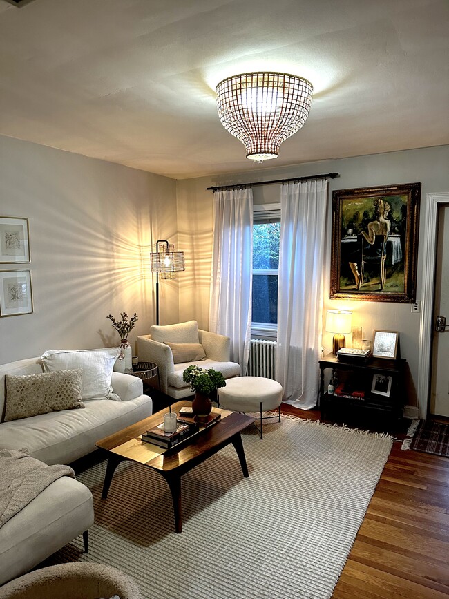 Living room with plenty of natural light and high-efficiency radiant heat for lower utility bills - 519 N Payne St